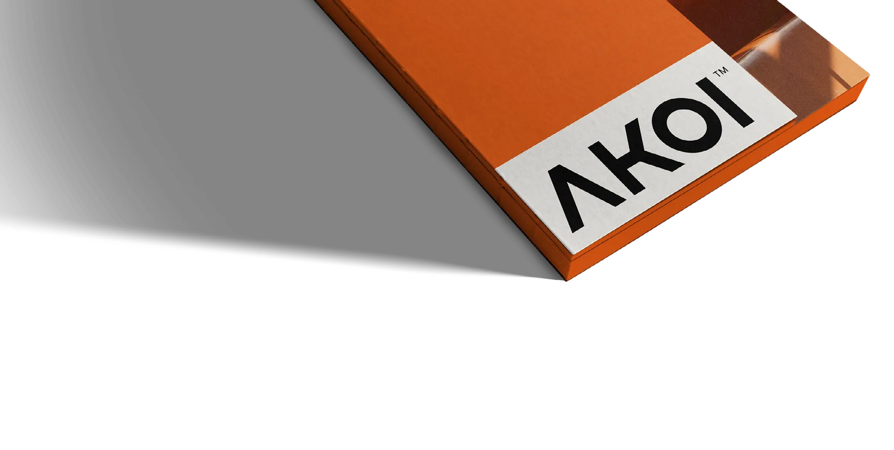 Stack of orange Akoi cards casting a long shadow