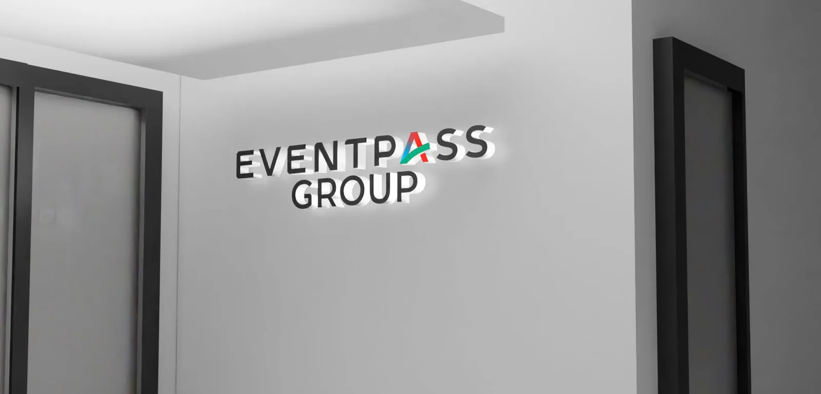 Eventpass Group logo mounted on a white office wall